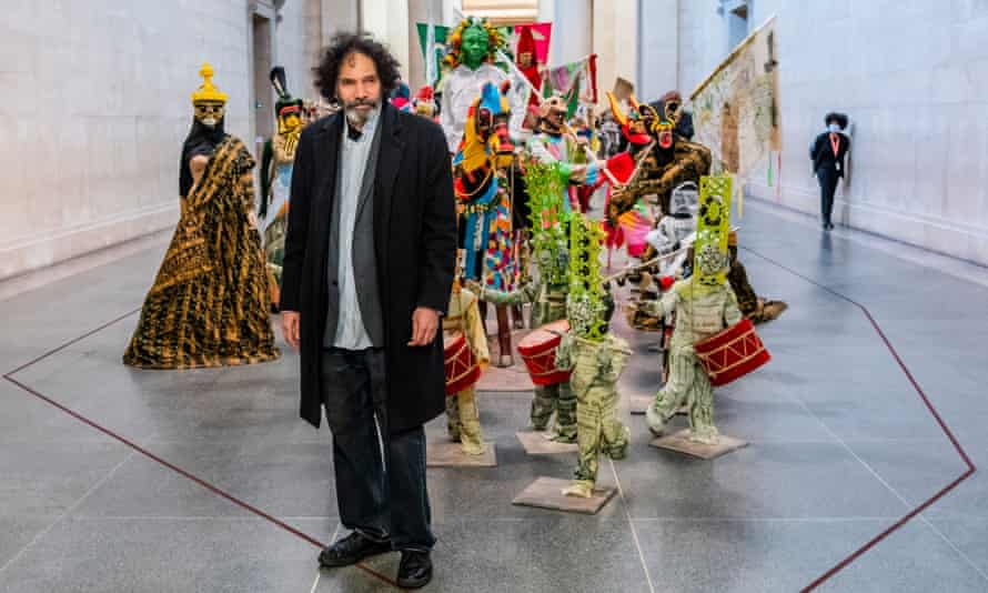 Hew Locke with his work