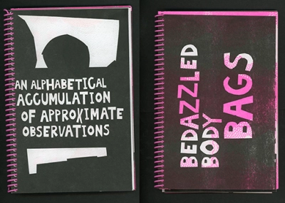 A book bound with a pink spiral with large, hand-cut lettering