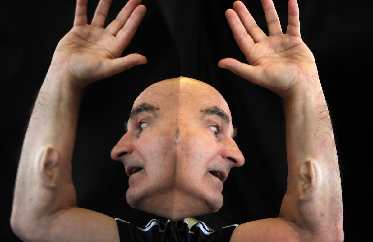 A duplicated image of a man with an ear in his arm.