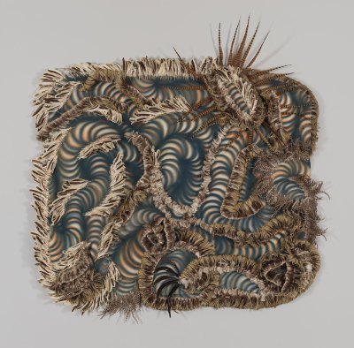 An abstract mixed-media painting made from acrylic and feathers on canvas. The paint shows spirals all over the canvas that mimic the patterning of the feathers. 