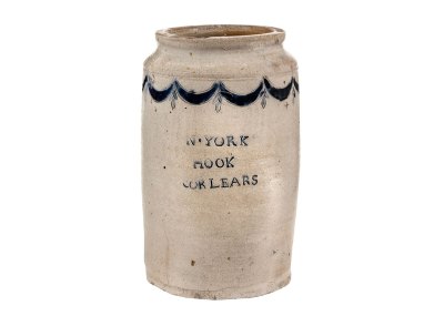 A stoneware jar in white with a pattern near its top and 'N•York Hook Corlears' written on it. 